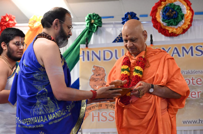 Hindu religious leader being honored by local community volunteers
