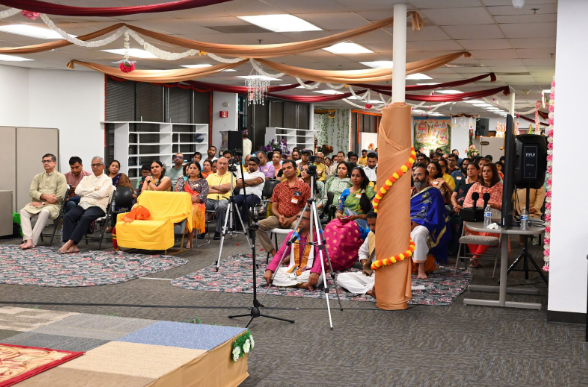Sacramento Hindu community members listening to a talk, in a temple hallway