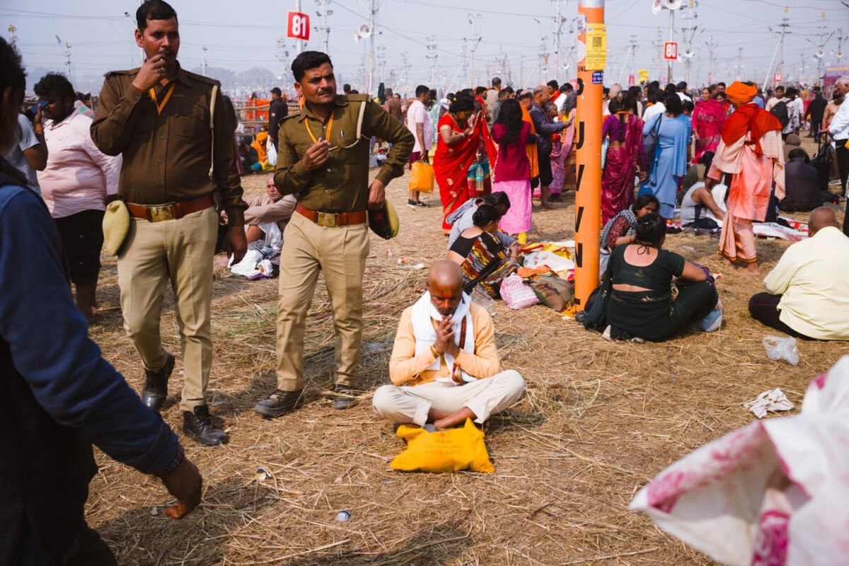 A man meditates in the middle of a crowd at the 2025 Kumbh Mela, Prayagraj, India