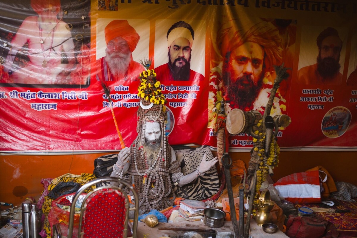 A sadhu wearing many rudraksha malas sings at the 2025 Kumbh Mela, Prayagraj, India