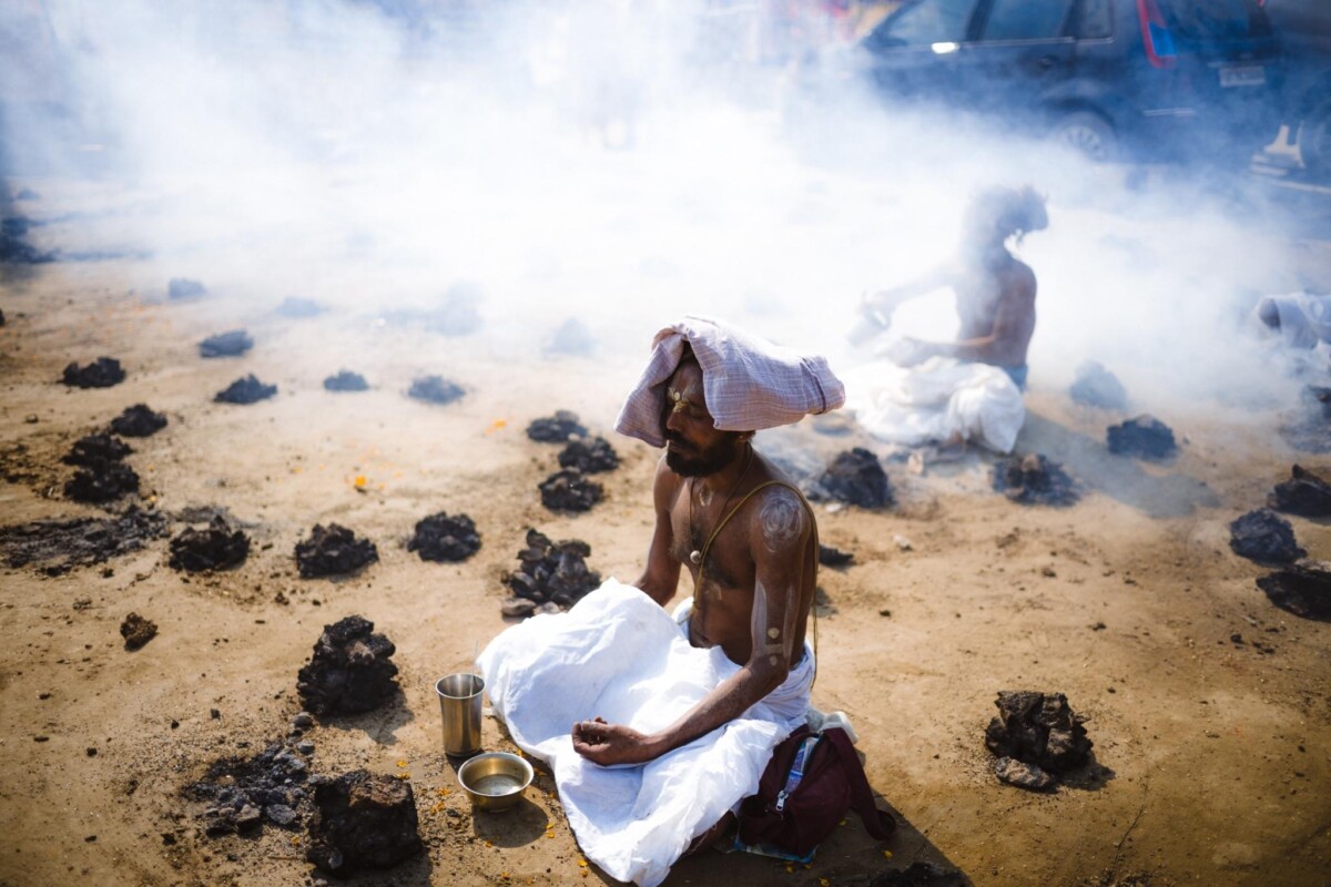 Sadhus meditate surrounded by burning cow dung fires at the 2025 Kumbh Mela, Prayagraj, India