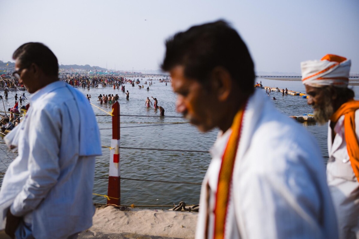 A view of people bathing taken from a bridge at the 2025 Kumbh Mela, Prayagraj, India